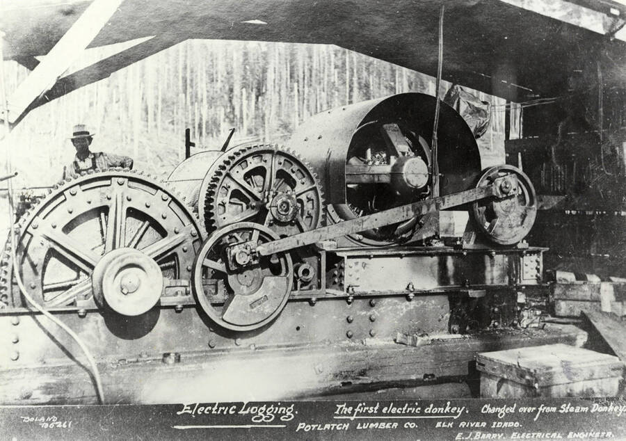 A photograph of the first electric donkey at the Potlatch Lumber Company's camp in Elk River, Idaho designed by electrical engineer E.J. Barry