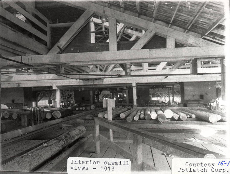 A photograph of an interior view of the sawmill in 1913 courtesy of Potlatch Corporation.