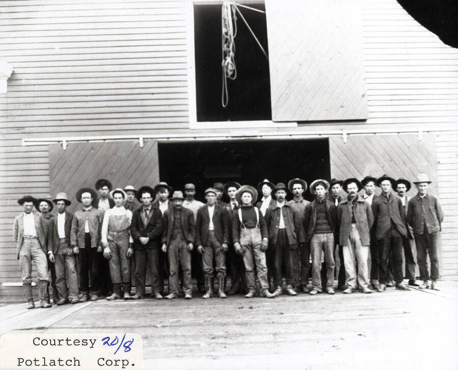 A photograph of employees at the sawmill.