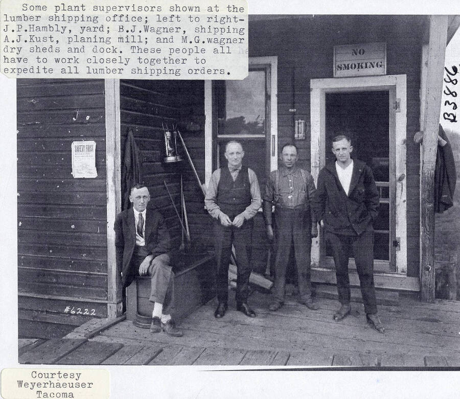 A photograph of J.P. Hambly, yard supervisor; B.J. Wagner, shipping supervisor; A.J. Kust, planing mill supervisor; and M.G. Wagner, dry sheds and dock supervisor at the lumber shipping office. They all had to work closely together to expedite lumber shipping orders.