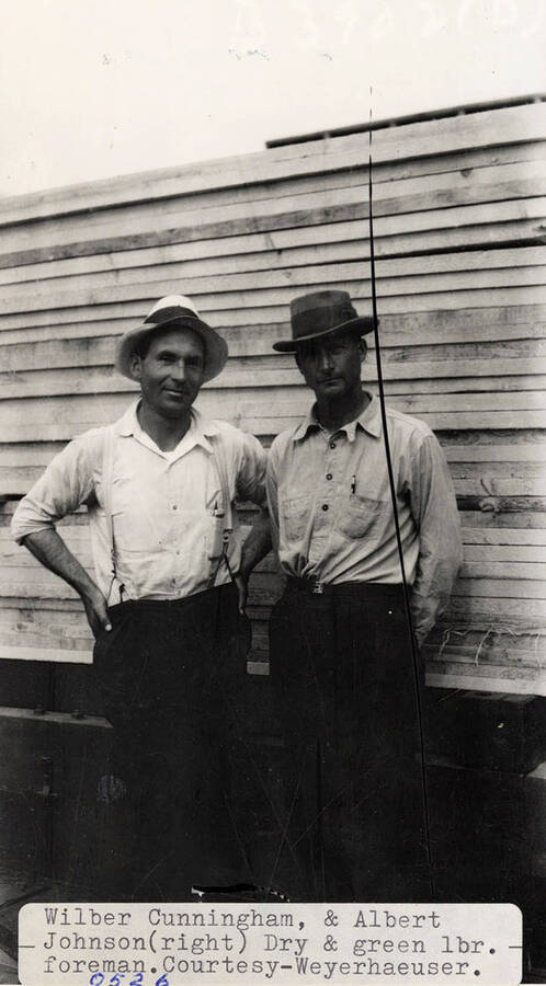 A photograph of dry and green lumber foreman Wilber Cunningham and Albert Johnson.
