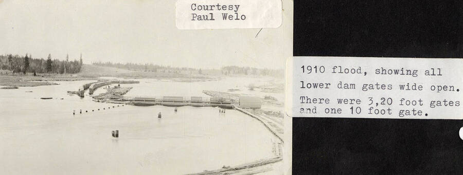 A photograph showing the three 20 foot gates and the one 10 foot gate open during the 1910 flood.