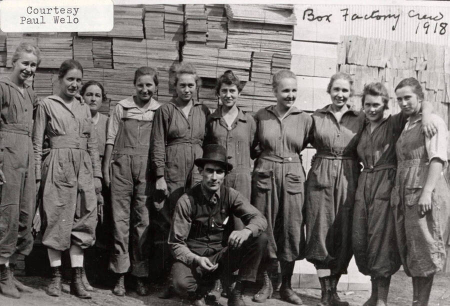 A photograph of the box factory crew with their supervisor.