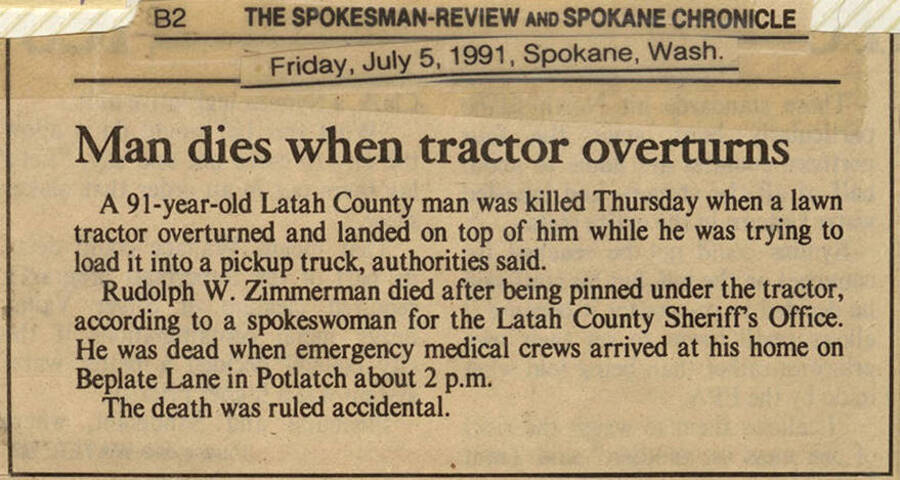 A newspaper clipping from The Spokesman-Review and Spokane Chronicle announcing Rudolph W. Zimmerman's death after being pinned under a tractor.