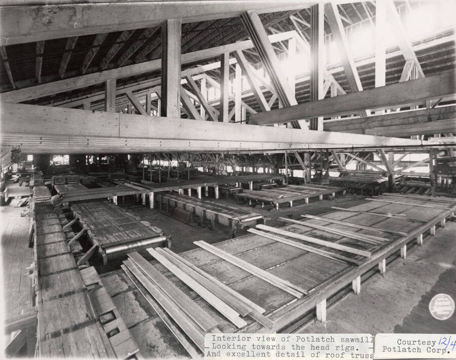 A photograph of the inside of Potlatch Sawmill looking towards the head rigs with excellent detail of the roof.