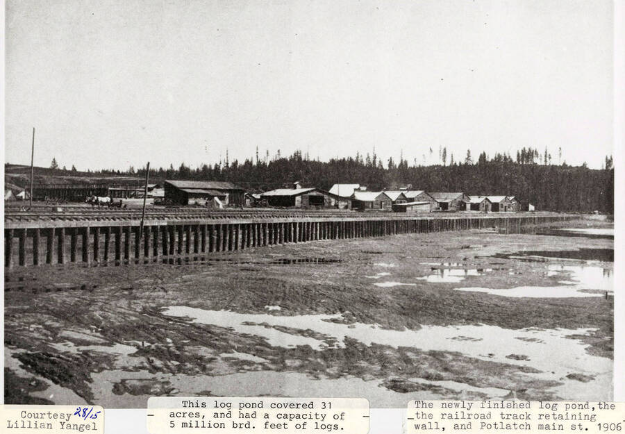 A photograph of the railroad track retaining wall, the Potlatch main street, and the newly built log pond that covered 31 acres and held 5 million brd. feet of logs. Courtesy of Lillian Yangel
