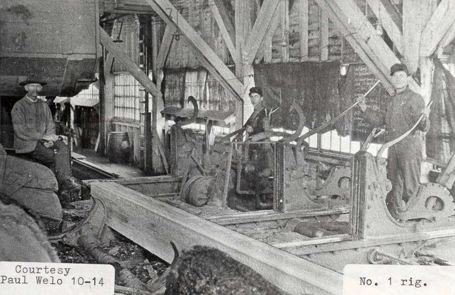 A photograph of the No. 1 rig with three employees.