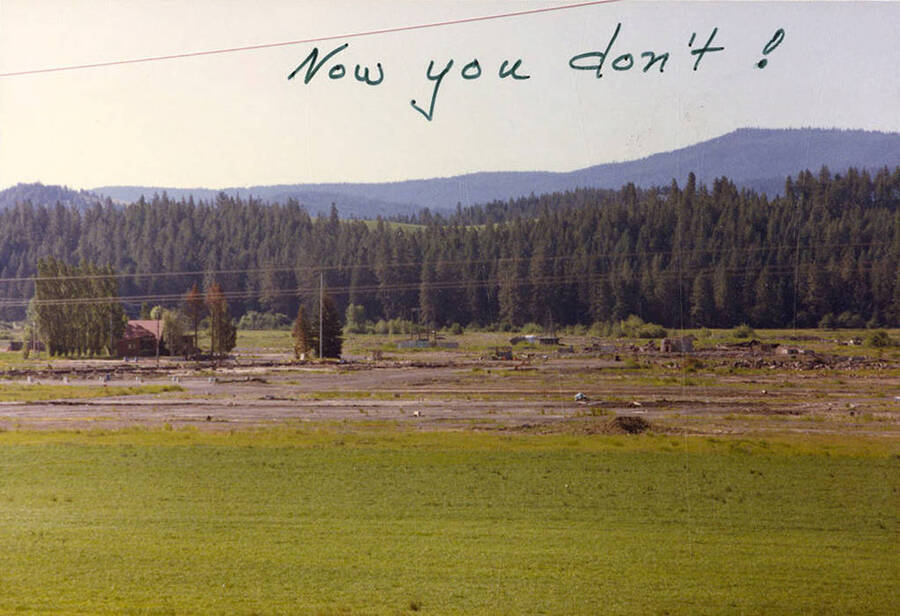 A photograph of the land where the three structures with three smokestacks behind them once stood.
