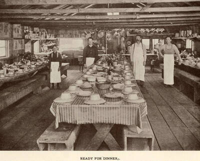 Tables set and ready for dinner at a logging camp.
