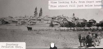 A photograph of a view of Potlatch, Idaho looking N.E. from the depot area where Pine St. is just below the houses.