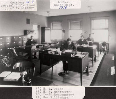 A photograph of the lumber sales department with H.L. Pelen, H.W. Chatterton, David Rossenberry, and Max Williamson.