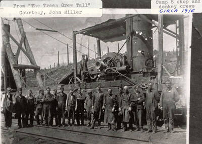 The Camp 8 shop and donkey crews standing around the steam donkey.