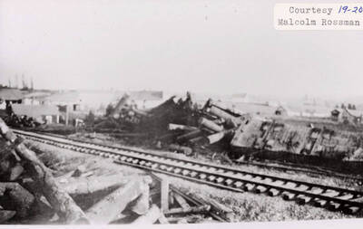 View of logging wreck. Logs can be seen surrounding the railroad tracks.