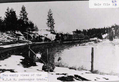 Early view of the WI&M passenger train surrounded by snow. The train can be seen on the railroad tracks.