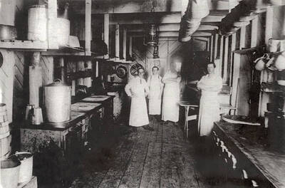 The cooking crew standing in the kitchen at one of the Potlatch camps.