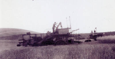 Threshing machine at work in the fields.