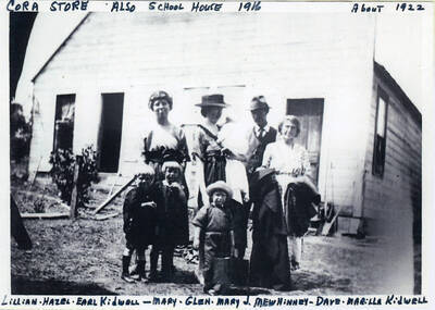 The Cora Store, built in 1916, also functioned as the schoolhouse. The people in the photo are: Lillian, Hazel, and Earl Kidwell; Mary, Glen, and Mary J. Mewhinney; and Dave and Marilla Kidwell.