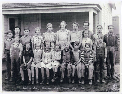 A 1940 class photo of the students at Chambers Flat School. Some student names are included but which name goes with which student is not identified: Lawrence Long, Willette West, Mae Carstens, Patricia Olfs, Helen Schott, Lyle Long, Alvin Wilson, Ernie Wilson, Charles Cochrane, Ruth Carstens, Pearl Krough, and Joyce Krough.