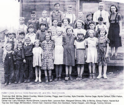 Students at the Hatter Creek School in 1938. Mr. and Mrs. Ted Grinolds were the teachers. Front row: Bob McVey, Melvin Crumley, Marvin Crumley, Peggy Jean Crumley, Nyla Chandler, Norma Gage, Myrtle Carlson, Ellen Patton, Jeanne Becker, Maxine Davidson. Middle row: Larry Davidson, Murtis Gilmore, Laverne Bain, Lavonne Bain, Margaret Gilmore, Billy Jo McVey, Elmay Patton, Harold Bull. Back row: Don Gage, Bill Davidson, Clinton Carr, Clarence West, Don Davidson, Harlan Hespen, John Benge, Tommy Gilmore, Mr. and Mrs. Grinolds.
