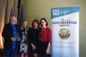 Photograph of Gary E. Strong receiving the Esto Perpetua Award at the Idaho State Historical Society. Lori Easley Otter, Janet Gallimore, and Amy Canfield are also pictured.