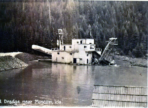 Photograph of the gold dredge on the Palouse River at the mouth of White Pine Creek.