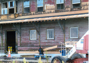 Photograph of the restoration of eaves and siding on the WI&M Depot.