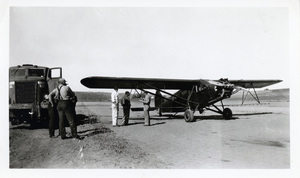 Photograph of men filling an airplane from a tanker filled with DDT in preparation for spraying the tussock moth.