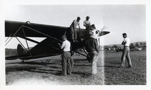 Photograph of Gordon Ellis and Wayne Cooper by an airplane ready to spray for the tussock moth.