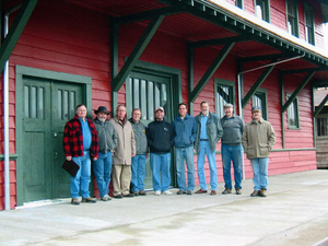 Photograph of the Board of Directors for the WI&M Railway HPG standing in front of the WI&M Depot in Potlatch. Identified directors are: Don Somers; Carl Sonner; Jim West; Tom Hildebrant; Lance Gallagher; Ken Vogel; Vandevord;Jack Coyner