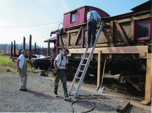 Photograph of Don Somers, Bob Behal and Bill Warner beginning restoration of the Caboose X-5.