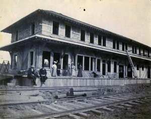 Photograph of people standing in front of the WI&M Depot in Potlatch during construction.