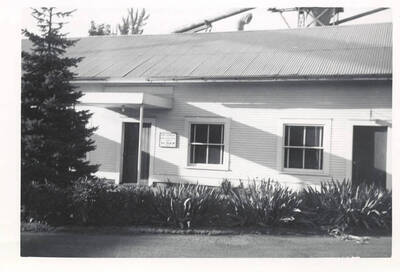 A photograph of an office building with nice landscaping.