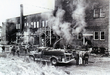 Photograph of the volunteer fire department putting out the fire at the Potlatch Mercantile.