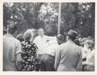 A man directing people to go through the line to get food.