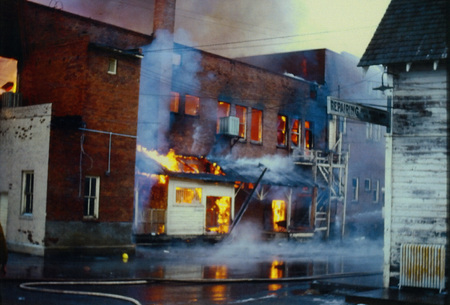 Photograph of the Mercantile fire. Back of building in flames.
