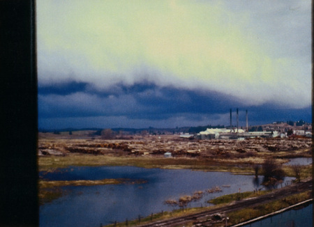 Photograph of the Potlatch Mill with the log pond in the foreground.