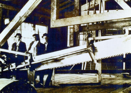 Photograph from slide of men with head saw in the Potlatch Mill.
