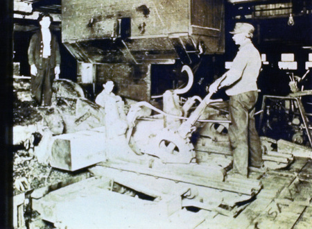 Photograph from slide of men on a carriage sawing logs at the Potlatch Mill.