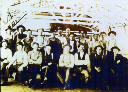 Photograph from slide of unidentified men on the green chain at the Potaltch Mill.