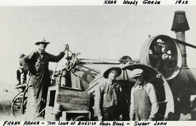Frank Hanna, Tom Lowe (of English royal blood), and Sweet John stand by some farming equipment near Woody Grade. Photograph taken in 1923.