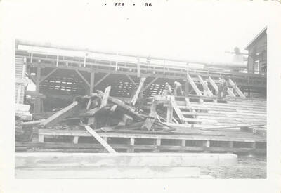 A group of people building the side of a structure.
