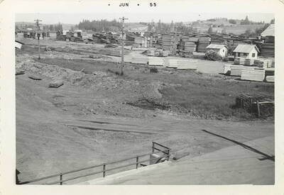 A photograph of the lumber yard from a distance.