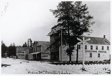 Photograph of Sherman House barber shop and drug store on south side of main street in Bovill, Idaho.