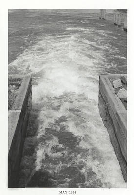 Water rushing from a controlled area to an open area.