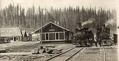 A photograph of the Elk River train station and a furniture store.
