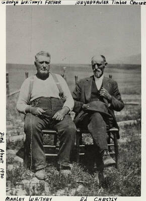 Manley Whitney and Ed Chestly sit together in chairs. Manley Whitney was George Whitney's Father. He died around 1930.