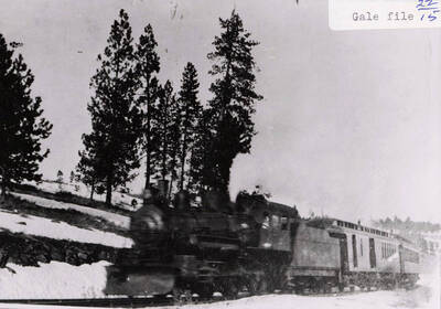Early view of the WI&M passenger train surrounded by snow. The train can be seen on the railroad tracks.