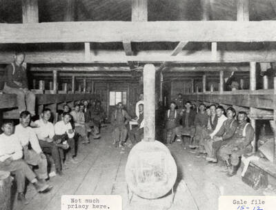 A group of men sitting in a cabin at one of the PLC camps.