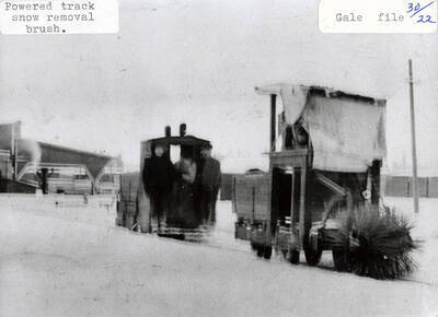 A photograph of the powered track snow removal brush.