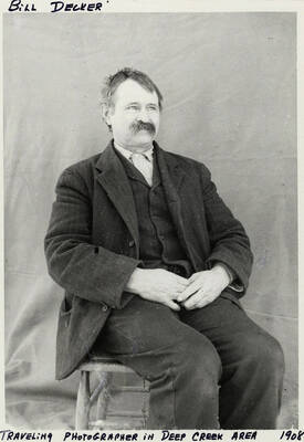 Bill Decker, a travelling photographer in the Deep Creek area, posing for a photograph. Photograph taken in 1908